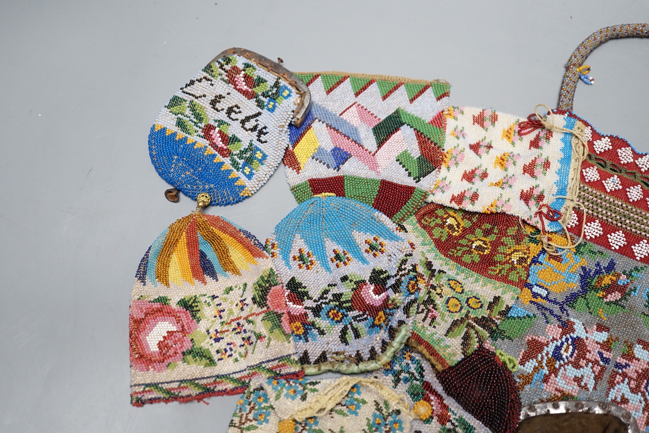 Three Victorian beadwork bags, circa 1860, largest 17cm high, and a collection of eleven smaller reticules and purses